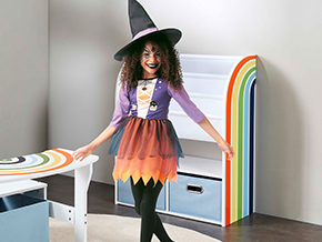 Mädchen ist in ihrem Kinderzimmer und trägt Halloween-Kostüm.